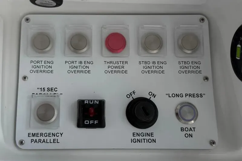 Slide: The Image of Control panel of 2025 HCB 48 Campeon boat with ignition and power override switches. - 42