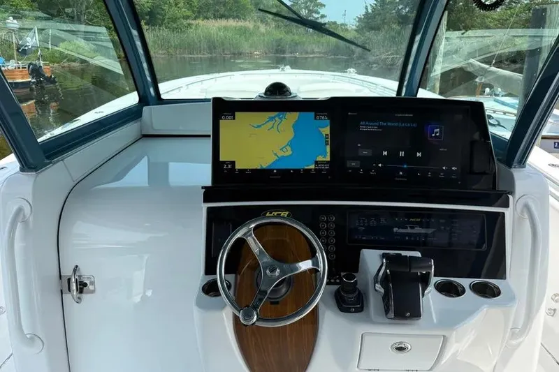 Slide: The Image of Helm of 2025 HCB 48 Campeon with navigation screens and steering wheel. - 43