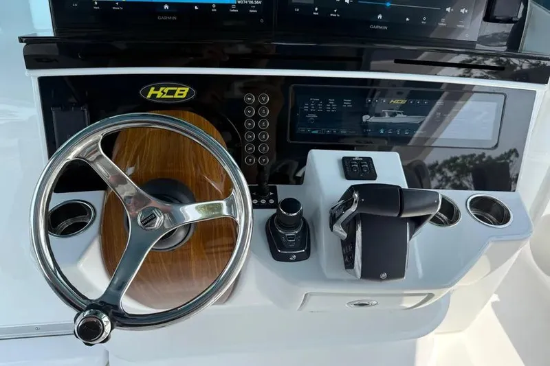 Slide: The Image of Helm of 2025 HCB 48 Campeon boat with steering wheel and controls. - 44