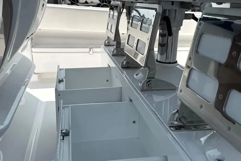 Slide: The Image of 2025 HCB 48 Campeon boat interior with open storage compartments and mounted equipment. - 46