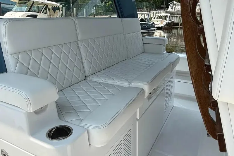 Slide: The Image of Luxurious seating on 2025 HCB 48 Campeon boat with quilted white upholstery. - 47