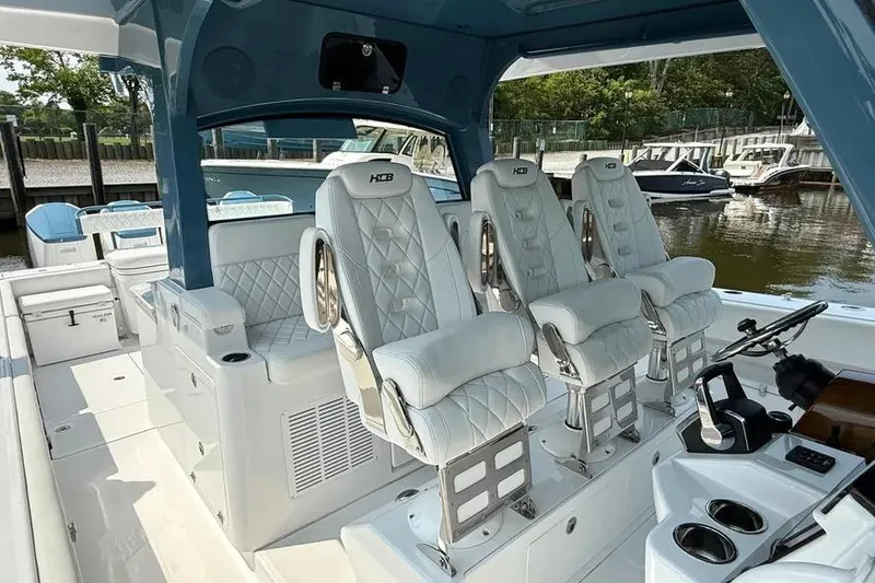 Slide: The Image of Luxury interior of 2025 HCB 48 Campeon boat with plush seating and modern controls. - 50