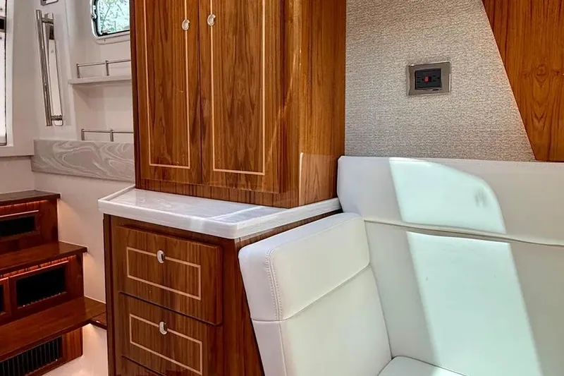 Slide: The Image of Luxurious interior of 2025 HCB 48 Campeon yacht with wood cabinetry and white seating. - 54