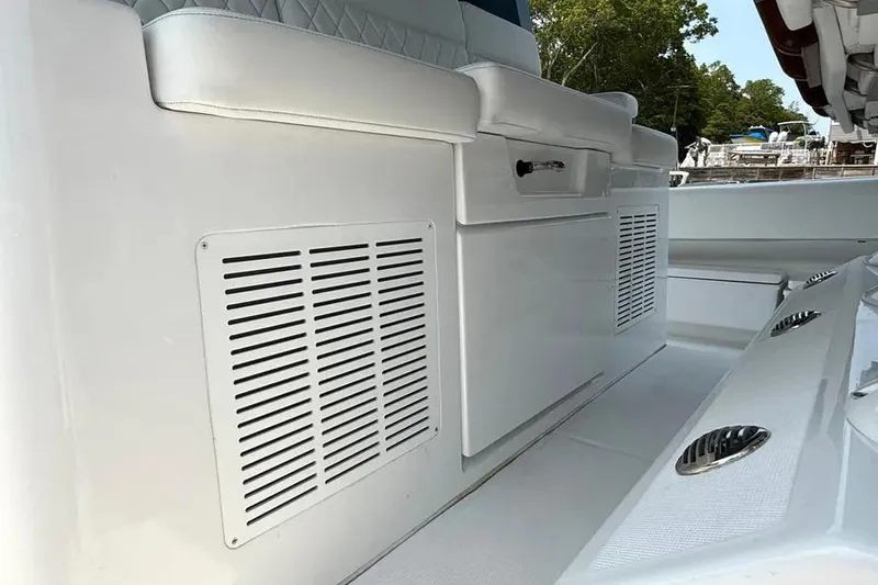 Slide: The Image of 2025 HCB 48 Campeon boat interior with white seating and storage compartments. - 58