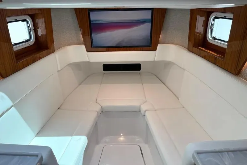 Slide: The Image of Luxurious interior of 2025 HCB 48 Campeon yacht with plush seating and large screen. - 59
