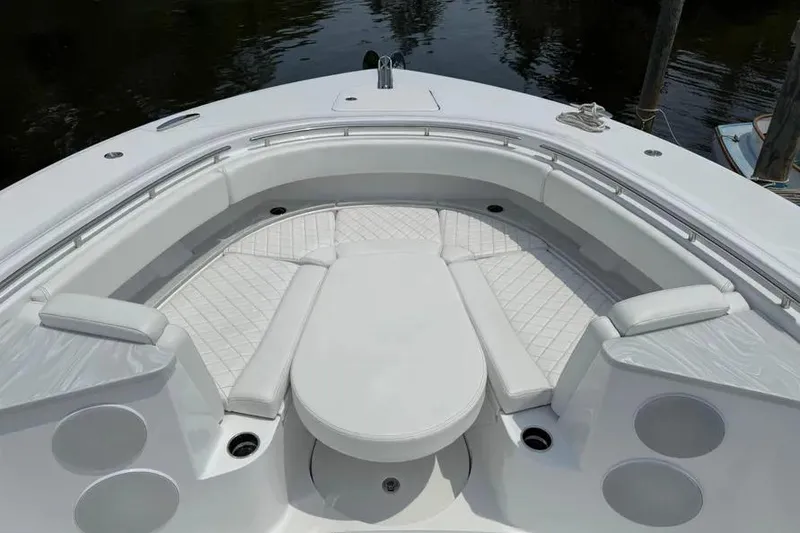 Slide: The Image of Luxurious seating area on 2025 HCB 48 Campeon boat, featuring white cushioned seats. - 6