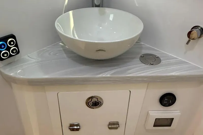 Slide: The Image of Modern bathroom sink in 2025 HCB 48 Campeon boat, featuring sleek design and control panel. - 61