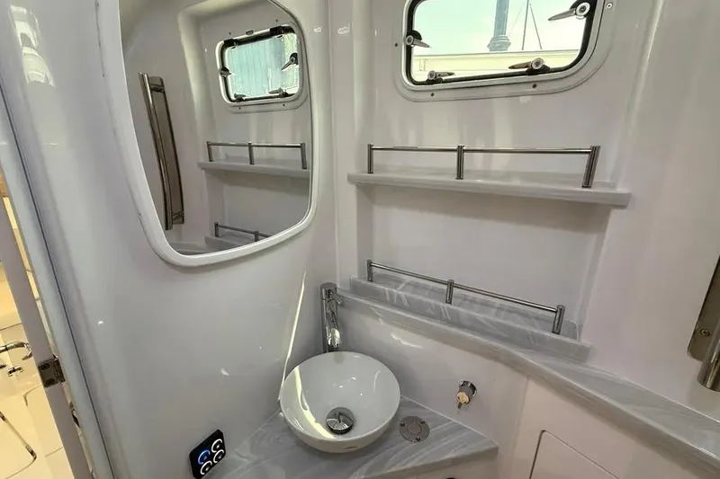 Slide: The Image of Modern bathroom interior of 2025 HCB 48 Campeon yacht, featuring sleek sink and windows. - 64