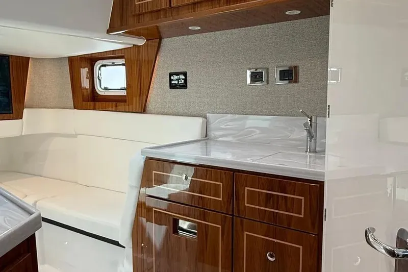 Slide: The Image of Luxurious interior of 2025 HCB 48 Campeon yacht with wood cabinetry and white seating. - 65