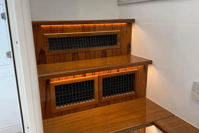 Slide: The Image of Wooden interior steps with ambient lighting on a 2025 HCB 48 Campeon boat. - 66