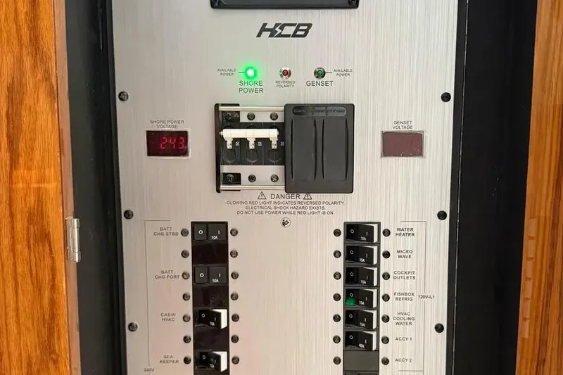 Slide: The Image of Electrical control panel on 2025 HCB 48 Campeon boat, showing shore power and circuit breakers. - 70