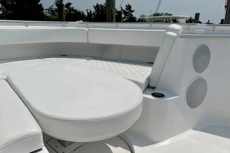 Slide: The Image of 2025 HCB 48 Campeon boat interior with white cushioned seating and sleek design. - 8