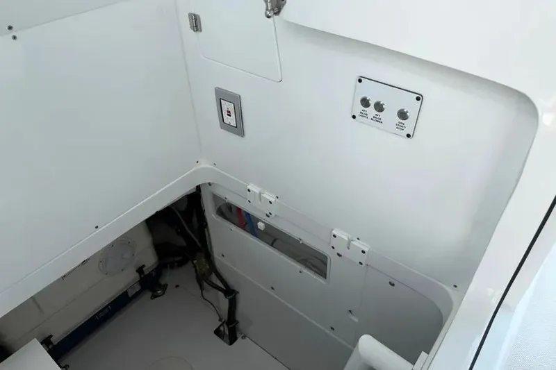 Slide: The Image of Interior view of 2025 HCB 48 Campeon boat, featuring control panel and storage area. - 80