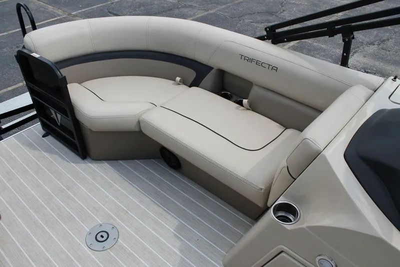 Slide: The Image of 2023 Trifecta 24UL-CS boat interior with beige seating and cup holders. - 11