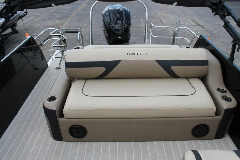 Slide: The Image of 2023 Trifecta 24UL-CS boat interior with beige seating and cup holders. - 17