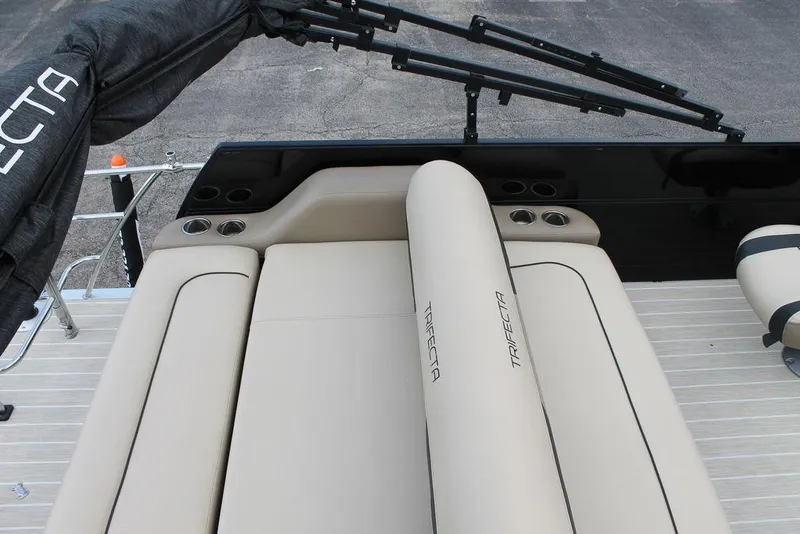 Slide: The Image of 2023 Trifecta 24UL-CS boat interior with beige seating and cup holders. - 7