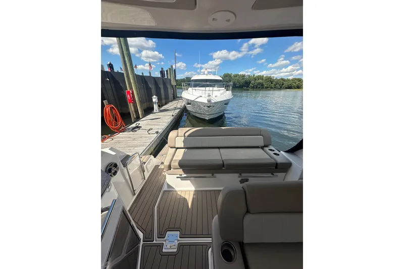 Slide: The Image of 2014 Regal 35 Sport Coupe docked, view from interior, sunny day, calm water. - 10