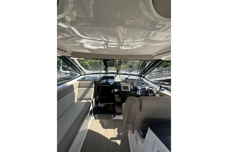 Slide: The Image of Interior view of 2014 Regal 35 Sport Coupe boat cockpit with seating and controls. - 11