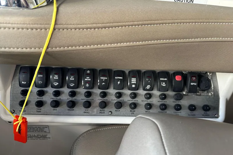 Slide: The Image of Control panel of a 2014 Regal 35 Sport Coupe boat with labeled switches. - 16