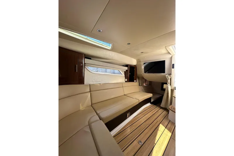 Slide: The Image of Luxurious interior of 2014 Regal 35 Sport Coupe with beige seating and wood flooring. - 20