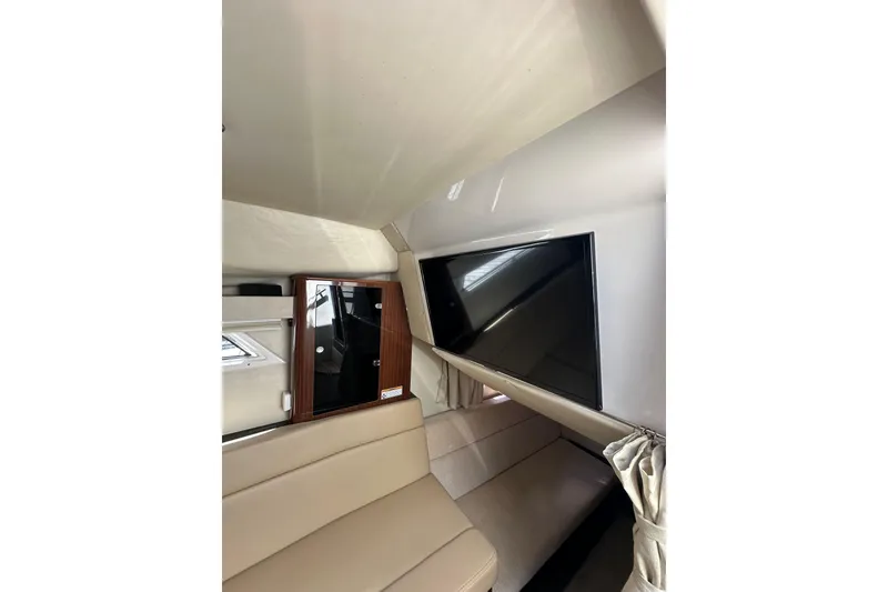 Slide: The Image of Interior of 2014 Regal 35 Sport Coupe with TV and beige seating. - 21