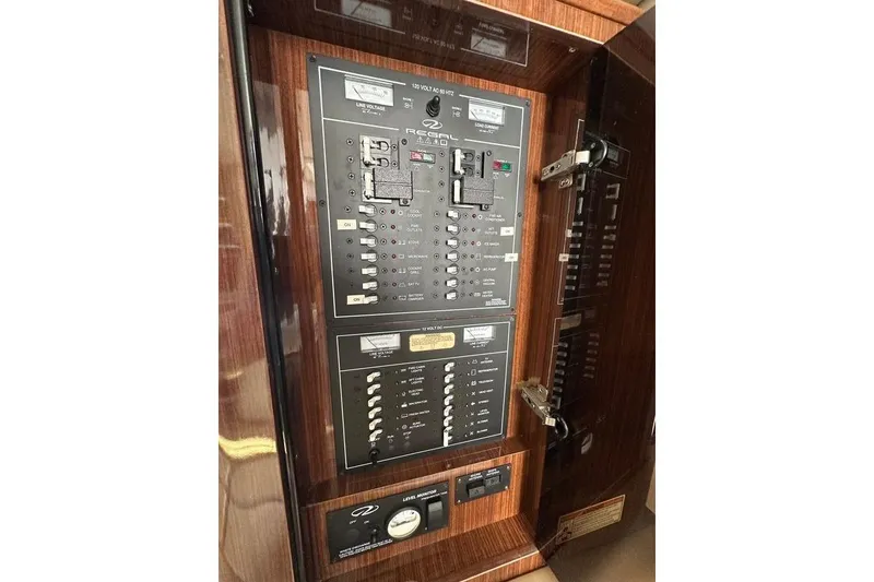 Slide: The Image of Electrical panel of a 2014 Regal 35 Sport Coupe boat, featuring switches and controls. - 24