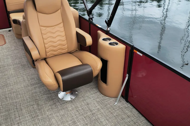 Slide: The Image of Luxurious seating on 2025 SunCatcher Fusion 324RC boat with cup holders and water view. - 10