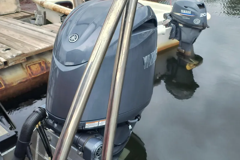 Slide: The Image of Yamaha outboard motors on a docked SunCatcher Fusion 324RC, 2025 model. - 12