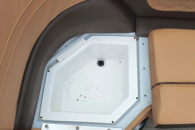 Slide: The Image of SunCatcher Fusion 324RC 2025 boat seating area with built-in storage compartment. - 4
