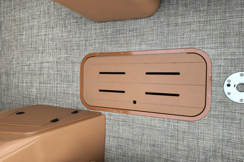 Slide: The Image of 2025 SunCatcher Fusion 324RC boat deck with tan hatch and textured flooring. - 5