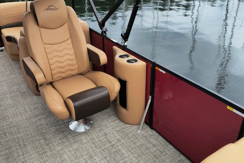 Slide: The Image of Luxurious seating on 2025 SunCatcher Fusion 324RC boat with cup holders and water view. - 7