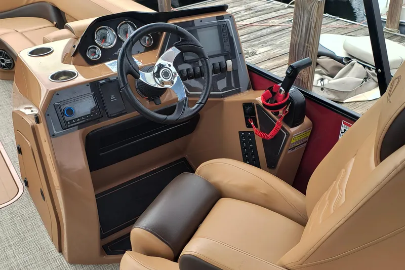 Slide: The Image of Interior of 2025 SunCatcher Fusion 324RC boat with steering wheel and control panel. - 8