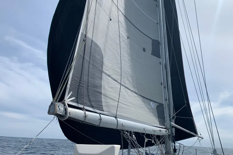 Slide: The Image of Sailing on a 1972 Tartan 41 yacht with full sails against a cloudy sky. - 11