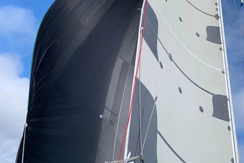 Slide: The Image of Sailing yacht Tartan 41, 1972 model, with large sails against a blue sky. - 13