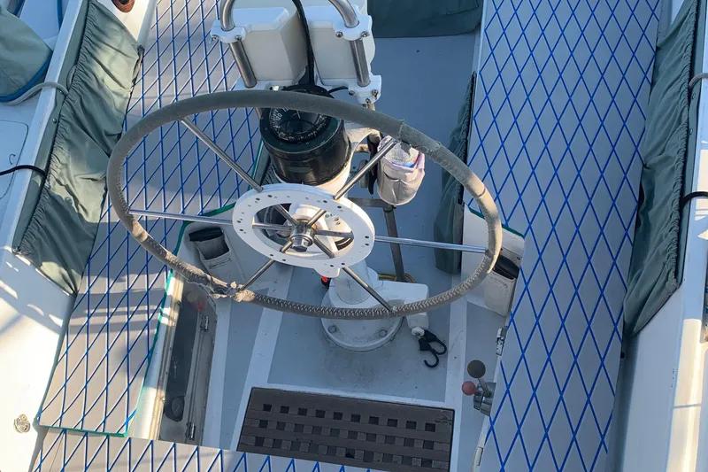 Slide: The Image of Cockpit of a 1972 Tartan 41 sailboat with a large steering wheel and compass. - 20