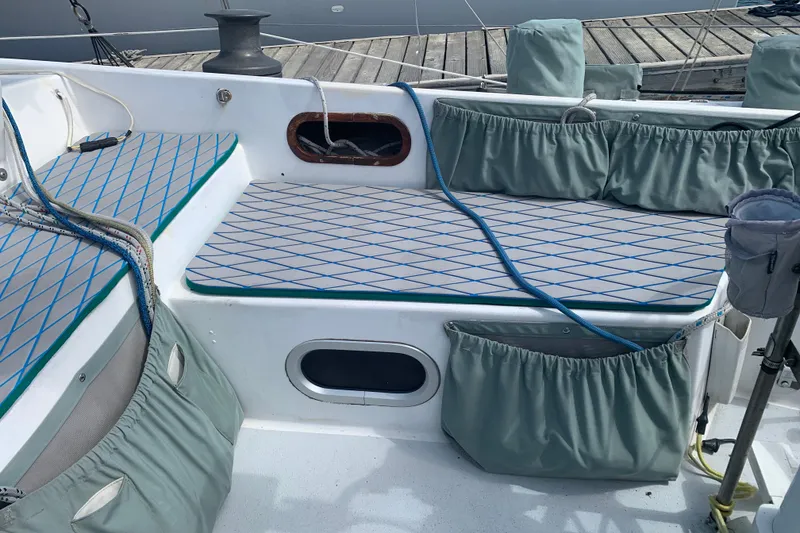Slide: The Image of Cockpit of 1972 Tartan 41 sailboat with cushioned seating and storage pockets. - 23