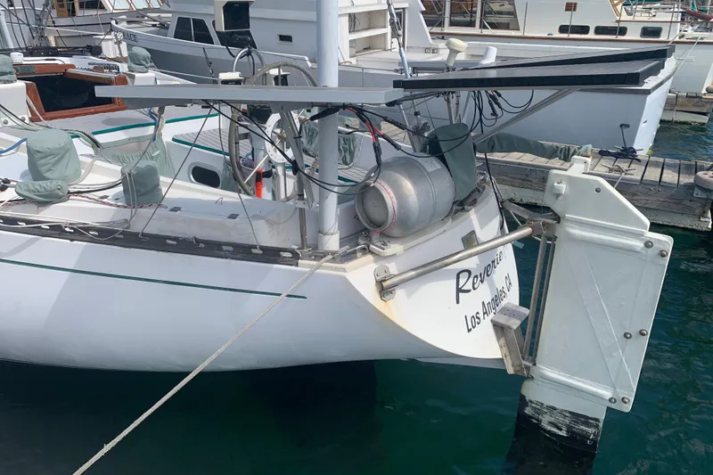 Slide: The Image of 1972 Tartan 41 sailboat docked, featuring a white hull and visible equipment. - 25