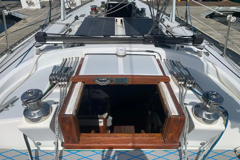 Slide: The Image of 1972 Tartan 41 sailboat deck with winches, ropes, and open cabin hatch. - 27