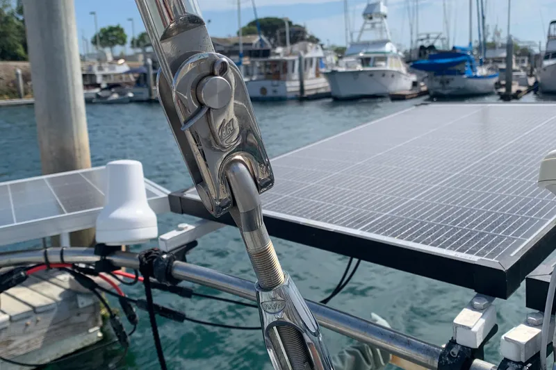 Slide: The Image of Close-up of a Tartan 41 sailboat's rigging with solar panels in a marina, 1972 model. - 28