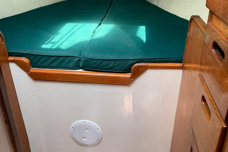 Slide: The Image of Interior of a 1972 Tartan 41 sailboat with green cushioned berth. - 29