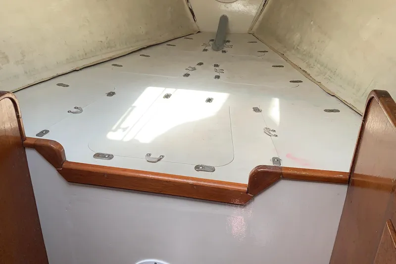 Slide: The Image of Interior of a 1972 Tartan 41 sailboat with wooden trim and storage compartments. - 30