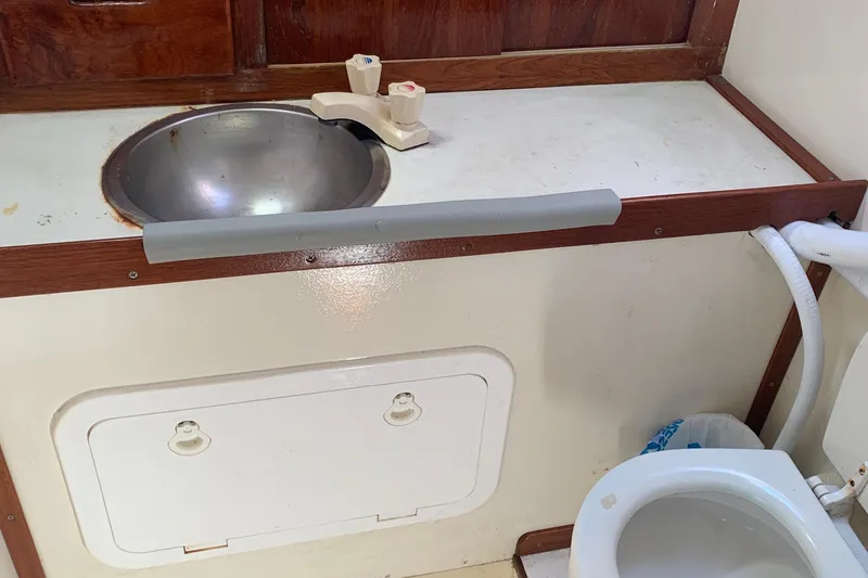 Slide: The Image of 1972 Tartan 41 yacht bathroom with sink and toilet, featuring wood accents. - 35