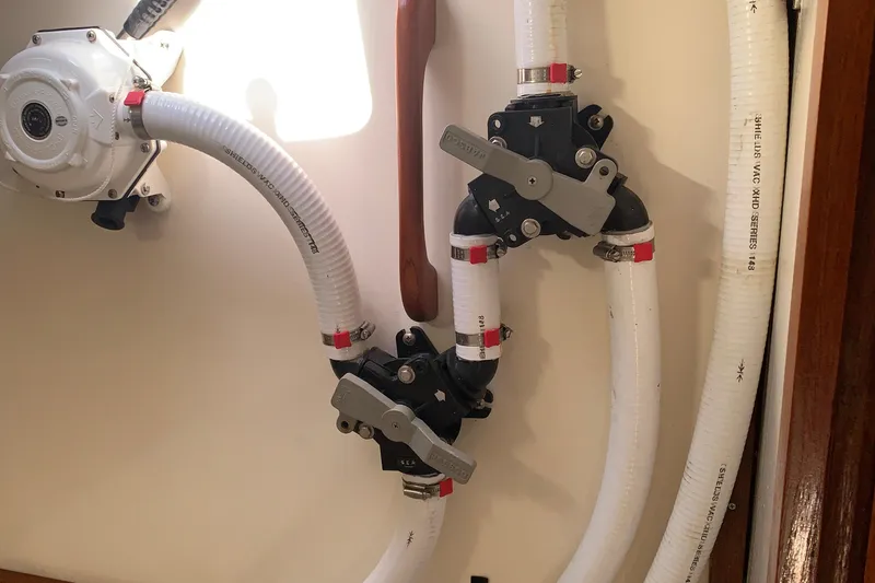 Slide: The Image of Plumbing system in a 1972 Tartan 41 sailboat, featuring hoses and valves. - 37