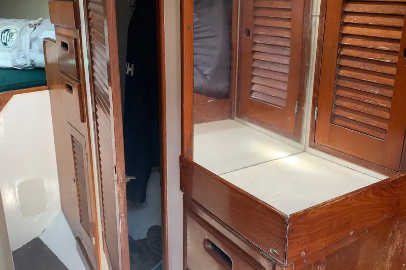 Slide: The Image of Interior of a 1972 Tartan 41 sailboat with wooden cabinetry and storage. - 38