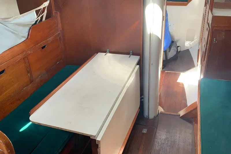 Slide: The Image of Interior of a 1972 Tartan 41 sailboat with wooden furnishings and a foldable table. - 41