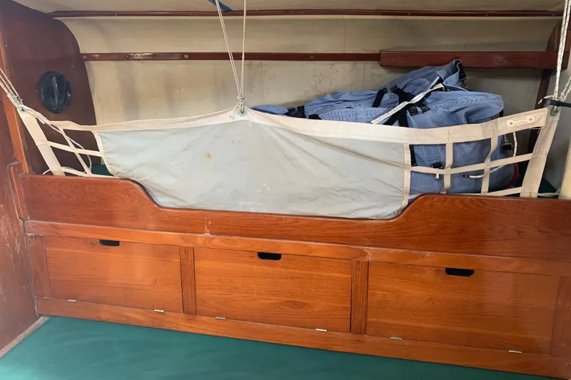 Slide: The Image of Interior of a 1972 Tartan 41 sailboat with wooden storage and netting. - 44