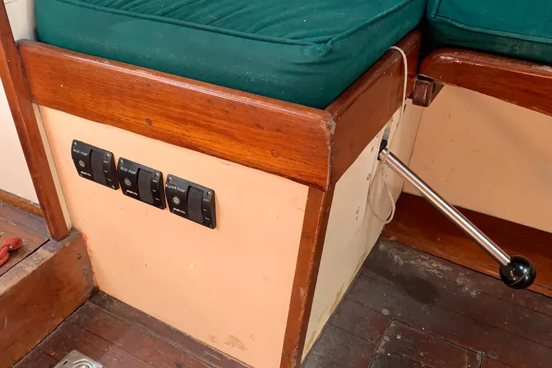 Slide: The Image of Interior of a 1972 Tartan 41 sailboat with control switches and wooden seating. - 46