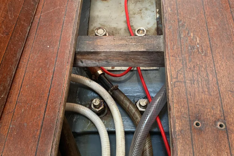 Slide: The Image of Wooden floorboards and hoses in a 1972 Tartan 41 sailboat interior. - 47
