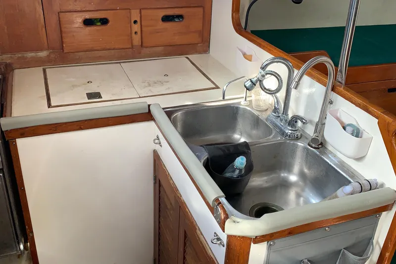Slide: The Image of 1972 Tartan 41 yacht kitchen with dual sinks and wooden cabinetry. - 50