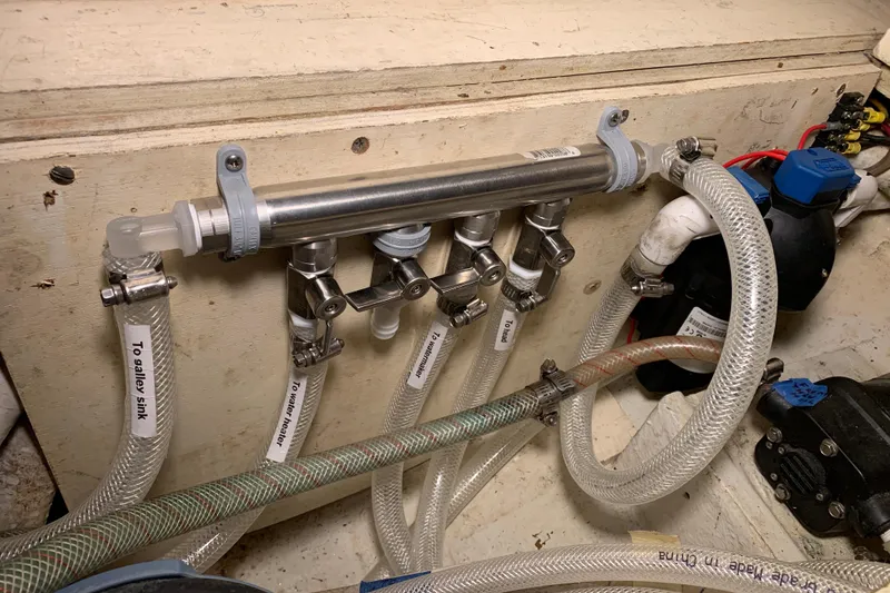 Slide: The Image of Plumbing system in a 1972 Tartan 41 boat with labeled hoses and valves. - 54
